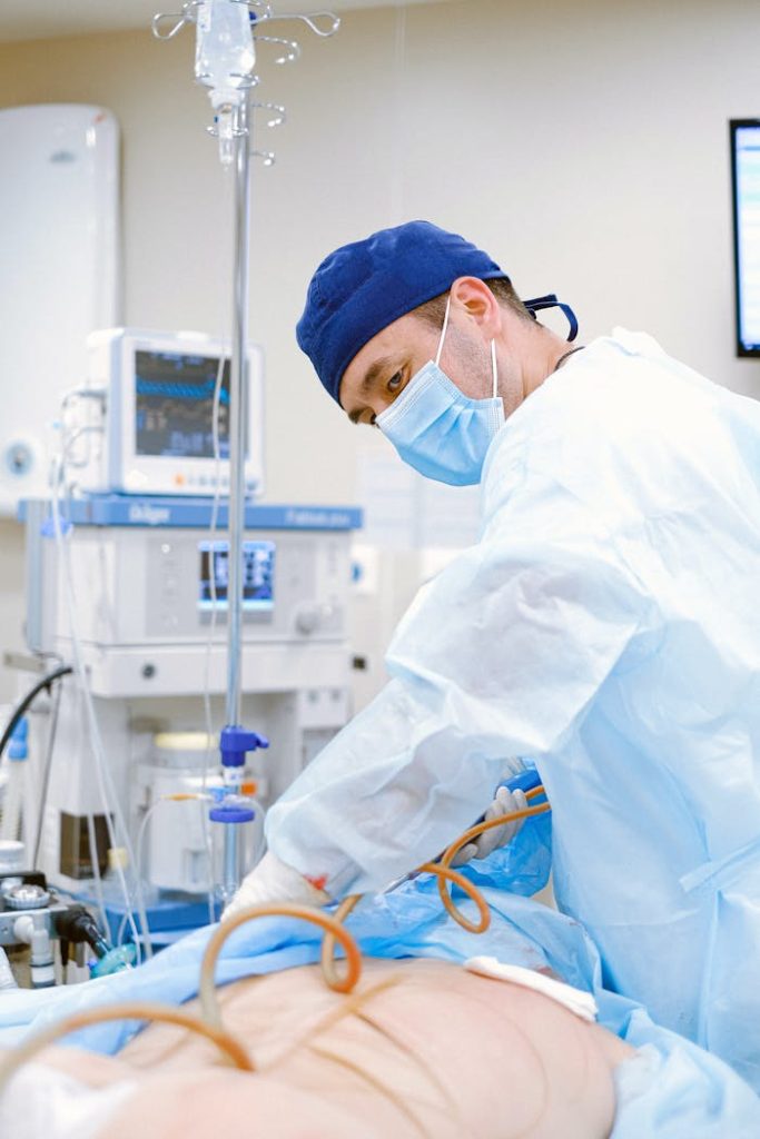 A surgeon performing a procedure in a sterile operating room setting.
